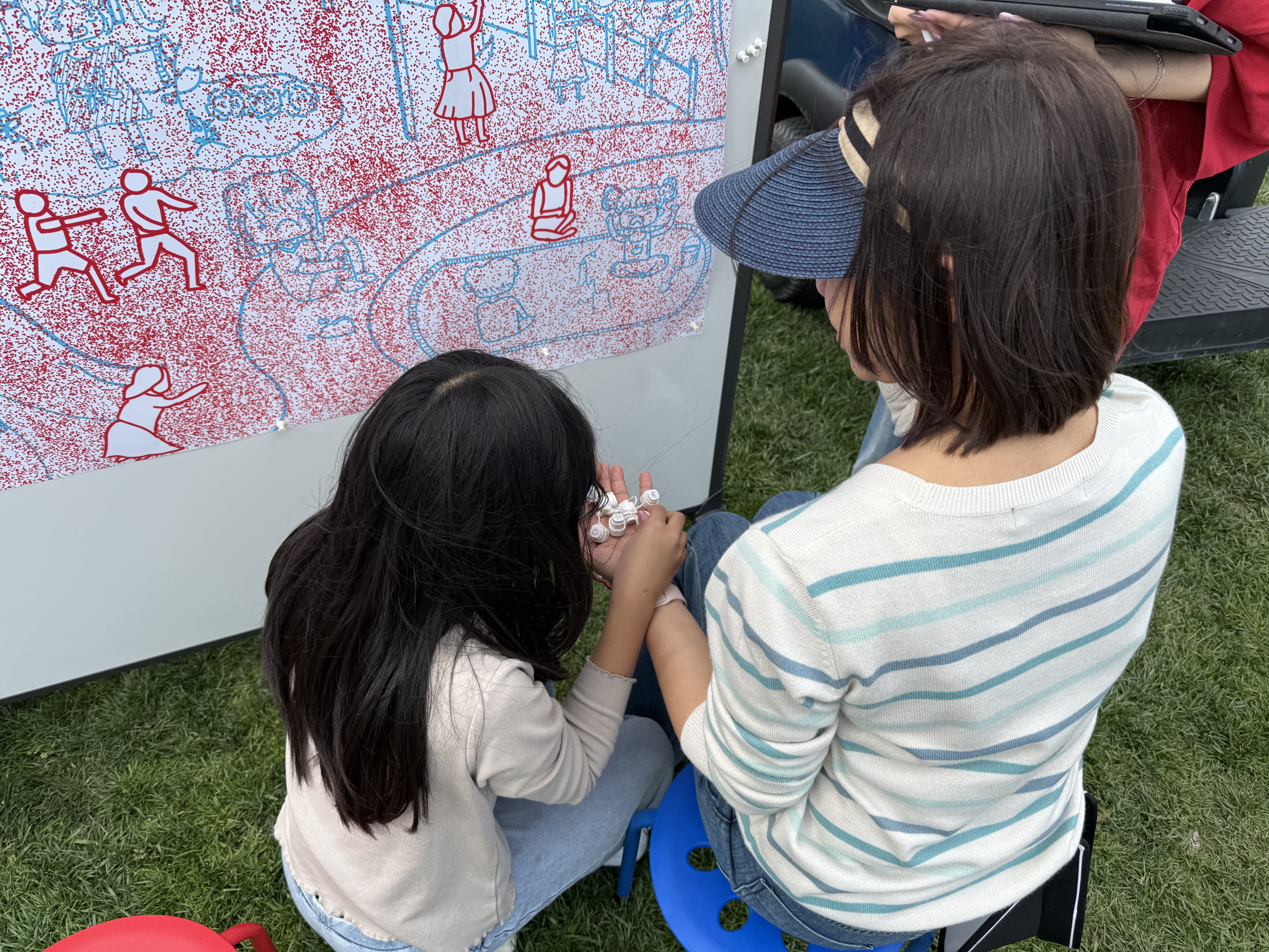 Children placing stickers at carnival